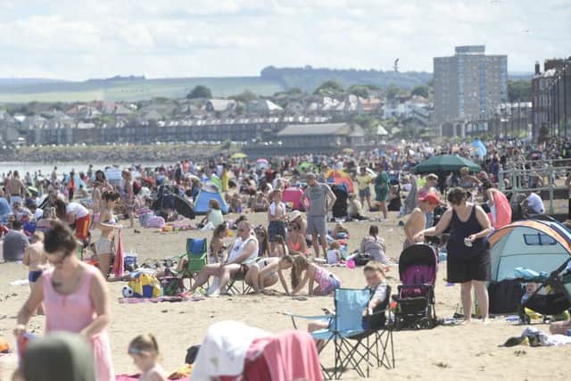 People enjoying the sunny weather at Portobello Beach. Picture; Greg Macvean
