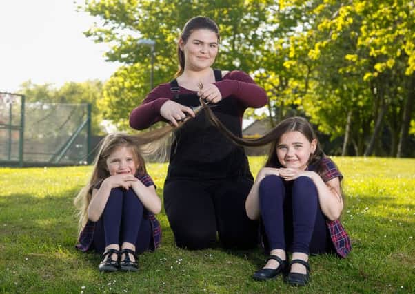 Alyx McLellan (5) and Brooke McLellan (8) are to have their hair cut for charity. Here they are posing with their big sister Zoe Blair(16).