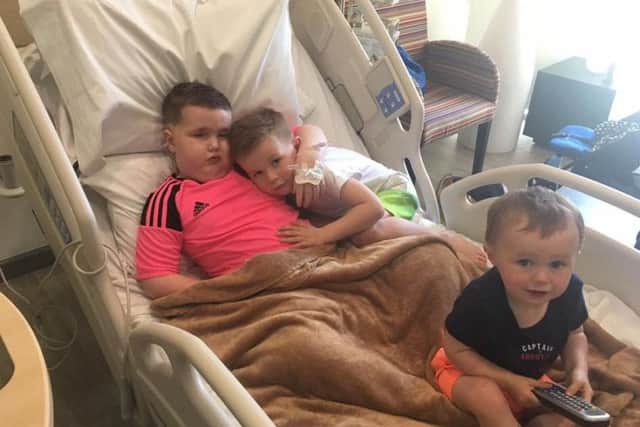 Luke Stewart in hospital in Nuevo Leon, Mexico undergoing treatment for his brian tumour
with his brothers Lewis and Lochlin.