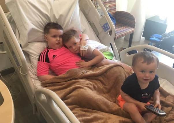 Luke Stewart  in hospital in Nuevo Leon, Mexico undergoing treatment for his brian tumour
with his brothers Lewis and Lochlin.