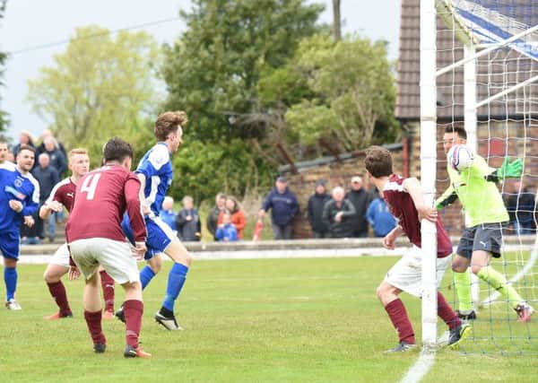 Roddy MacLennan's header just creeps over the line to give Bo'ness the lead against Linlithgow. Pic: David Lamb