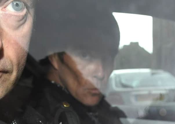 Singer Ian Brown from Stone Roses leaves Lanark Sheriff Court in an unmarked police car. Picture: SWNS