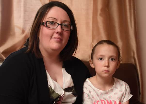 Megan Donald, 7, from Kirkintilloch, Scotland, with mum Natalie, 31, whose tongue got stuck in a Disney Monster Inc cup. Picture: SWNS