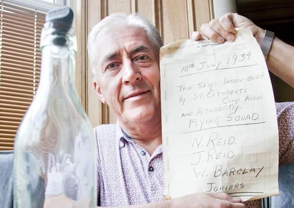 James Barclay with the message hidden in a bottle by his father Willie Barclay.