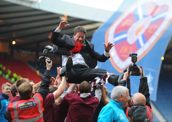 Hearts players lift Paulo Sergio into the air after Hearts' 5-1 victory over Hibs. Pic: TSPL