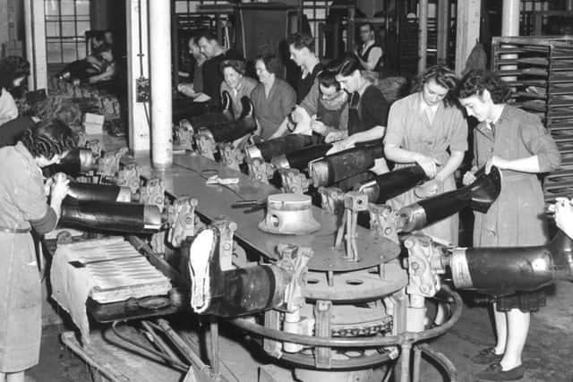 Workers putting the boot on the shop floor. Picture: TSPL