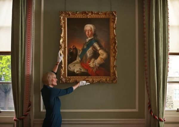 A portrait of Bonnie Prince Charlie receives its final inspection from senior curator Deborah Clarke at the Palace of Holyrood House . PIC:  Stewart Attwood.