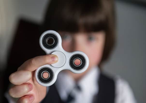 Fidget spinners have captivated kids on both sides of the Atlantic. Picture: John Devlin