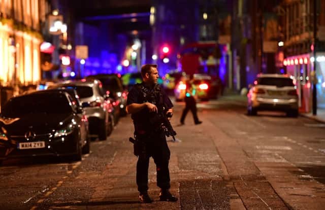Armed police on Borough High Street as police deal with a "major incident" at London Bridge. Picture: PA