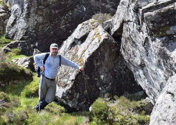 Glen MacDonald, vice chairman of the 1745 Association, at the possible site of Cluny's Cage by two boulders thought to have acted as a natural fireplace. PIC: Contributed.