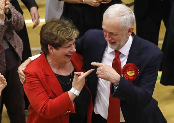 Jeremy Corbyn, right, gestures toward Labour's Emily Thornberry after arriving for the declaration at his constituency in London. Picture: AP