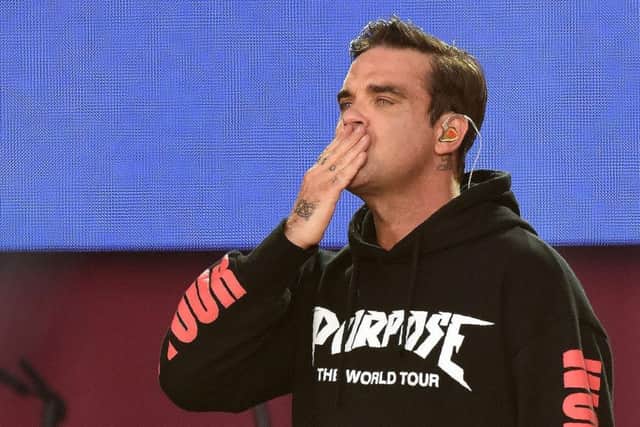 Robbie Williams performs at the One Love Manchester Picture; Getty