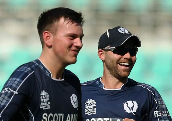 Scotland's Mark Watt, left, celebrates a wicket with team-mate Preston Mommsen