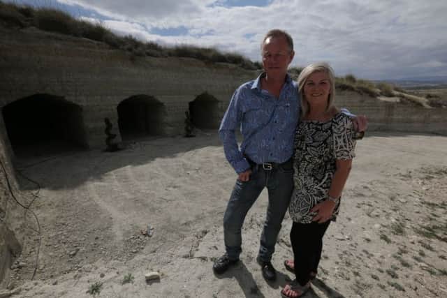 Mark and Shirley Graham in front of the cave before its renovation.