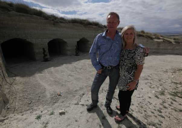Mark and Shirley Graham in front of the cave before its renovation.