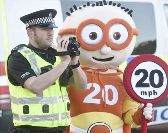 Edinburgh Council 20mph mascot The Reducer  with PC Ben Wray. Picture: Greg Macvean