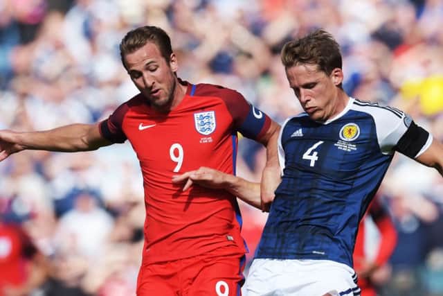 England's Harry Kane is challenged by Hearts captain Christophe Berra