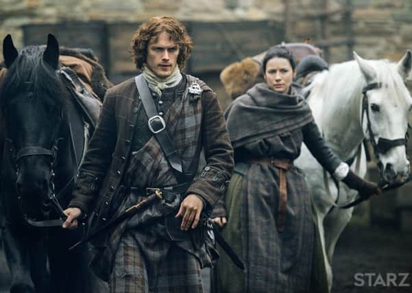 Sam Heughan as Jamie Fraser with his co-star Caitriona Balfe as Claire Randall Fraser. PIC: Starz.