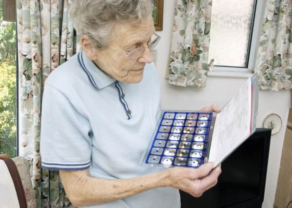An elderly woman with an lectronic pill tray. Picture: EM Welch/REX/Shutterstock