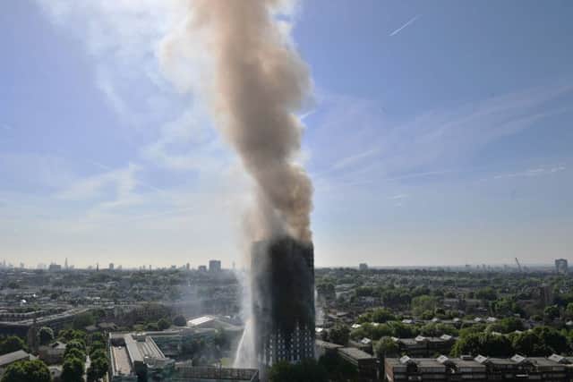 Smoke billows from a fire that has engulfed the 24-storey Grenfell Tower in west London. Picture: Victoria Jones/PA Wire
