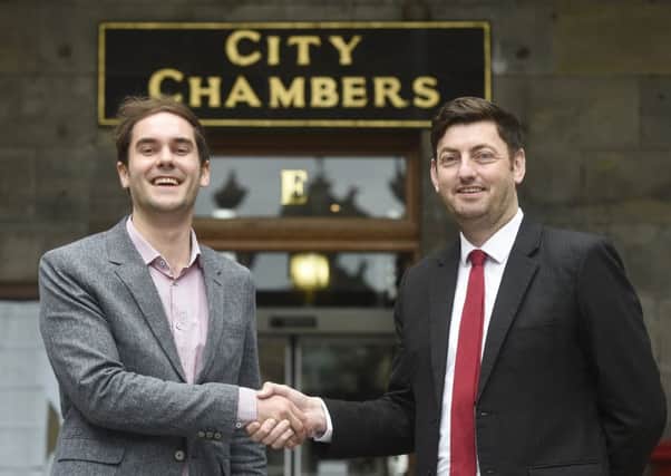 SNP leader Adam McVey and Labour counterpart Cammy Day shake hands on their coalition deal at City Chambers. Picture: Greg Macvean