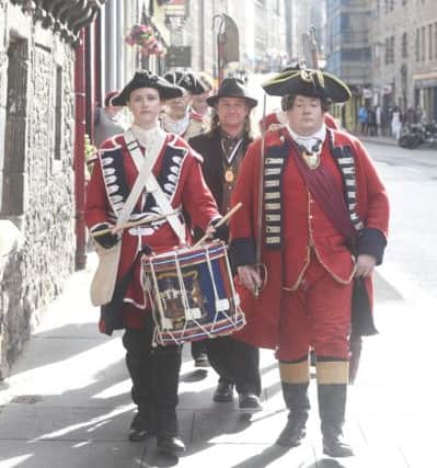 Reenactors marching down the Royal Mile to the Museum with Councillor Baillie Staniforth. Picture; Greg Macvean