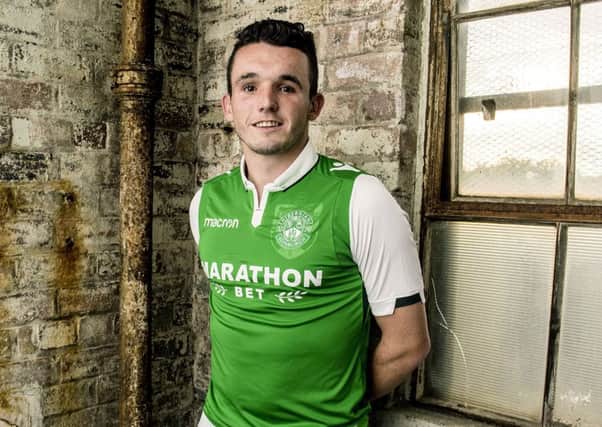 John McGinn models the new home kit at the Biscuit Factory