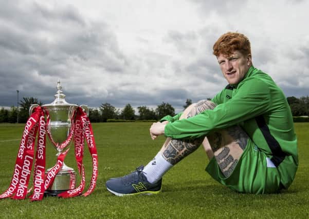 Simon Murray relaxes with the Scottish Championship trophy at East Mains