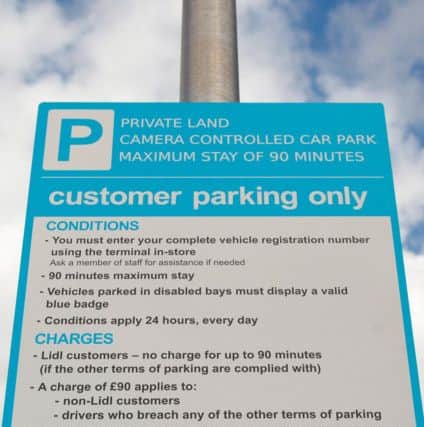 Signage detailing parking restrictions at the Penicuik Lidl store car park where non-shoppers can be charged Â£90.00 if they leave their vehicle in the car park.
