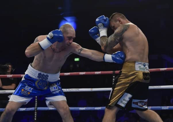 Stephen Simmons lands a blow on Lukasz Rusiewicz. Pic: Andrew O'Brien