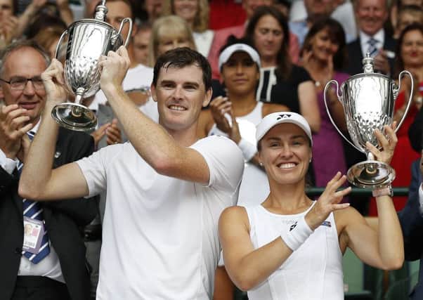 Jamie Murray (L) and Switzerland's Martina Hingis hold their mixed doubles winners trophies aloft. Picture: Getty