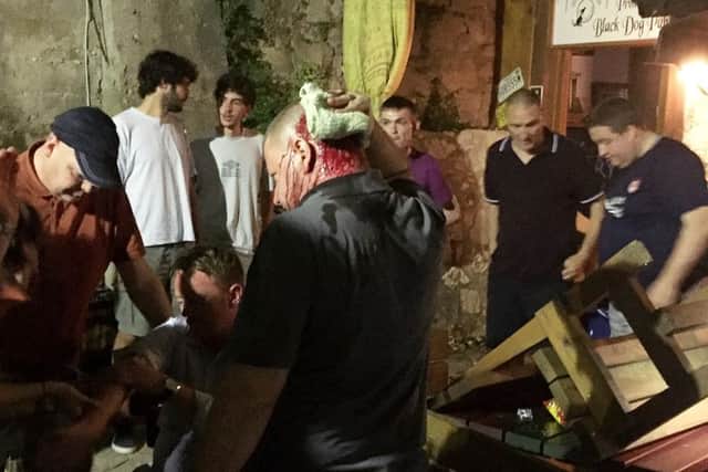 An Aberdeen fan holds his head after an incident in a bar as they gather ahead of their match against NK Siroki Brijeg. Picture; SNS