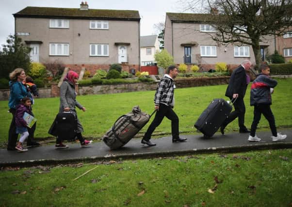 Syrian refugee families arrive at their new homes in Scotland. Picture: Getty Images