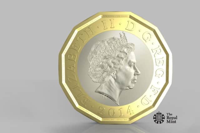 The new coin. One pound sterling. The Royal Mint.