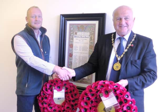 Provost Adam Montgomery (on right) presents the two wreaths to Brian Harrison to be laid as part of the centenary commemorations of the Third Battle of Ypres, commonly known as Passchendaele.