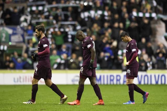 SORE: Hearts players trudge off after defeat by Hibs. Picture: SNS