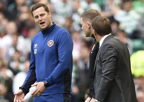 Hearts interim manager Jon Daly has words with Celtic manager Brendan Rodgers. Picture: Ian Rutherford/PA Wire
