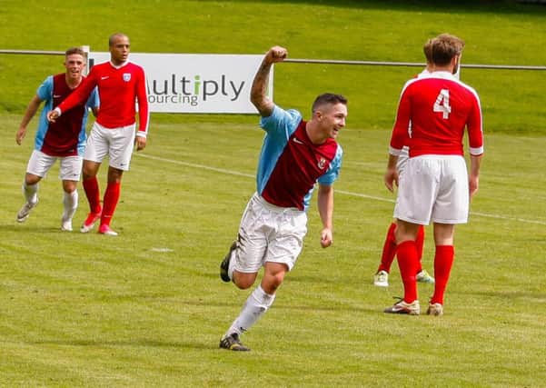 Darren McCraw celebrates opening the scoring against Edusport but later suffered an injury