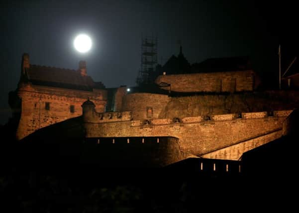 The Sturgeon Moon rose above Edinburgh Castle on Monday night. Picture: PA