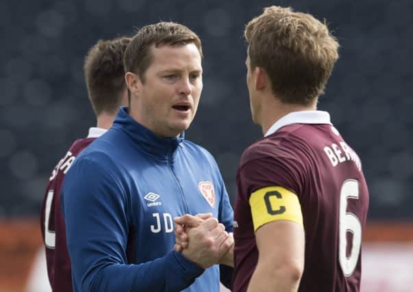 Jon Daly shakes hands with Hearts captain Christophe Berra at full time