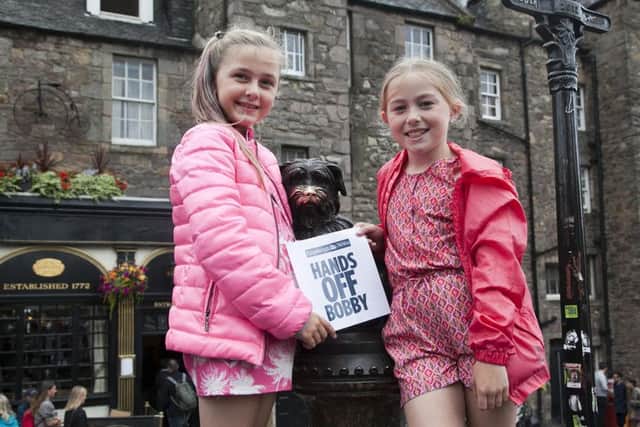 Olivia, left, and Daisy Kennedy help publicise the Hands off Greyfriars Bobby campaign. Picture: Alistair Linford