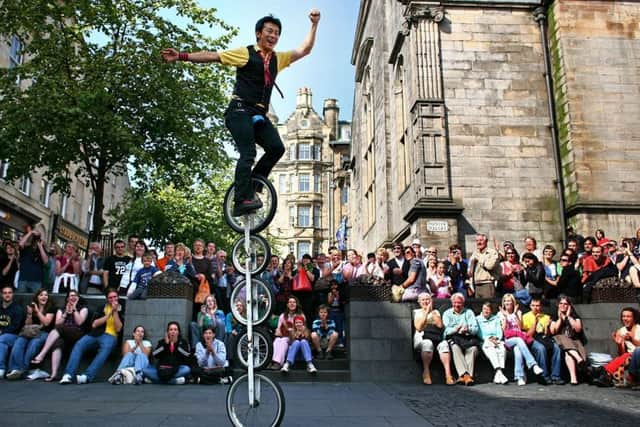 A street entertainer performs on the Royal Mile during the Fringe. Picture: Getty
