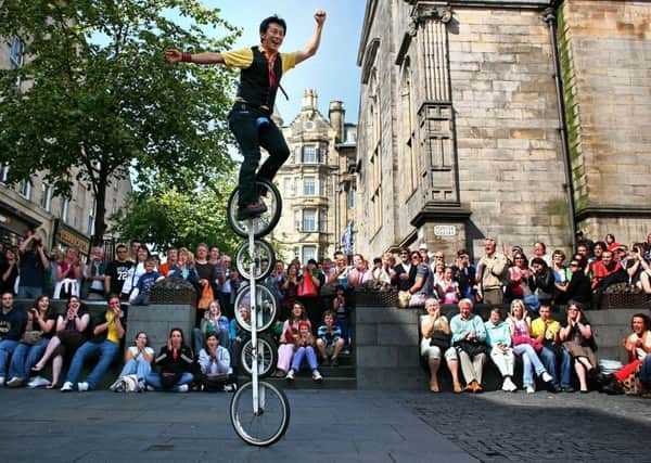 A street entertainer performs on the Royal Mile during the Fringe. Picture: Getty