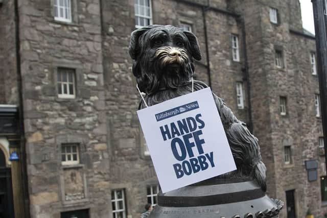 An Evening News sign placed on Greyfriars Bobby yesterday.