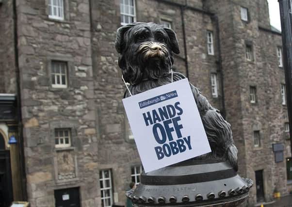 An Evening News sign placed on Greyfriars Bobby yesterday.