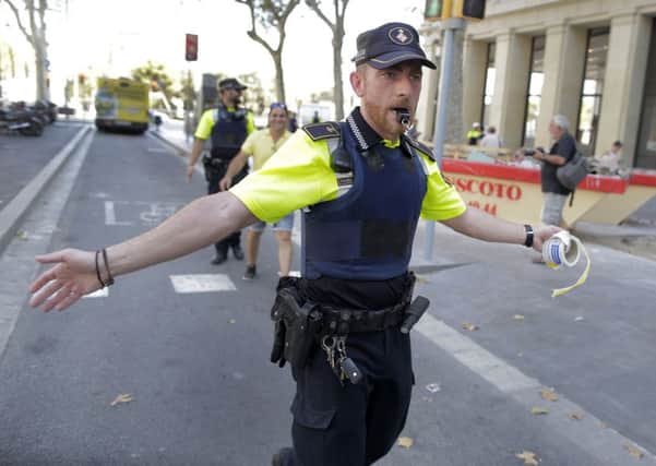 A police officer cordon off a street in Barcelona, Spain. (AP Photo/Manu Fernandez)