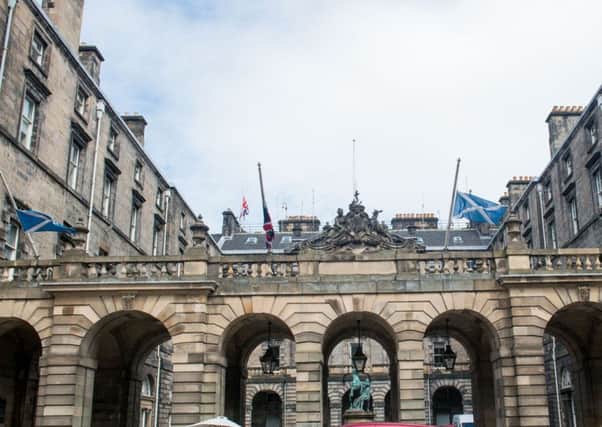 Flags fly half mast outside the Scottish Parliament and City Chambers in Edinburgh. Picture; Ian Georgeson