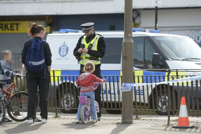 Police on Ferry Road, Edinburgh, Scotland, after a 10-year-old boy was seriously injured in a hit and run incident after being struck by a motorbike. Picture; SWNS