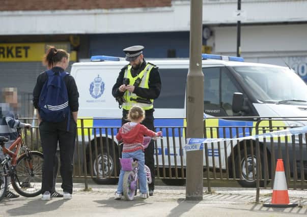 Police on Ferry Road, Edinburgh, Scotland, after a 10-year-old boy was seriously injured in a hit and run incident after being struck by a motorbike. Picture; SWNS