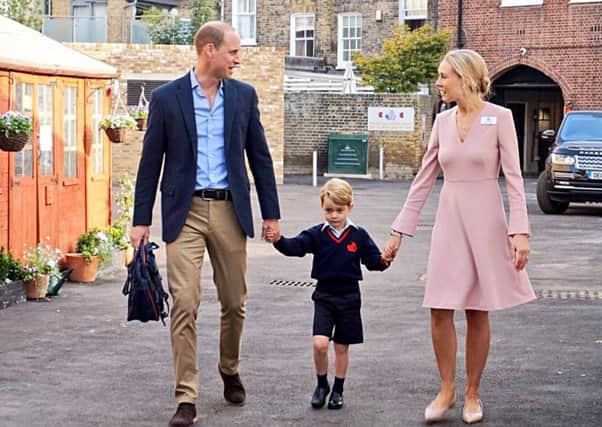 Prince George arrives at school holding hands with the Duke of Cambridge and Helen Haslem, head of the lower school, at Thomas's Battersea. Picture: PA